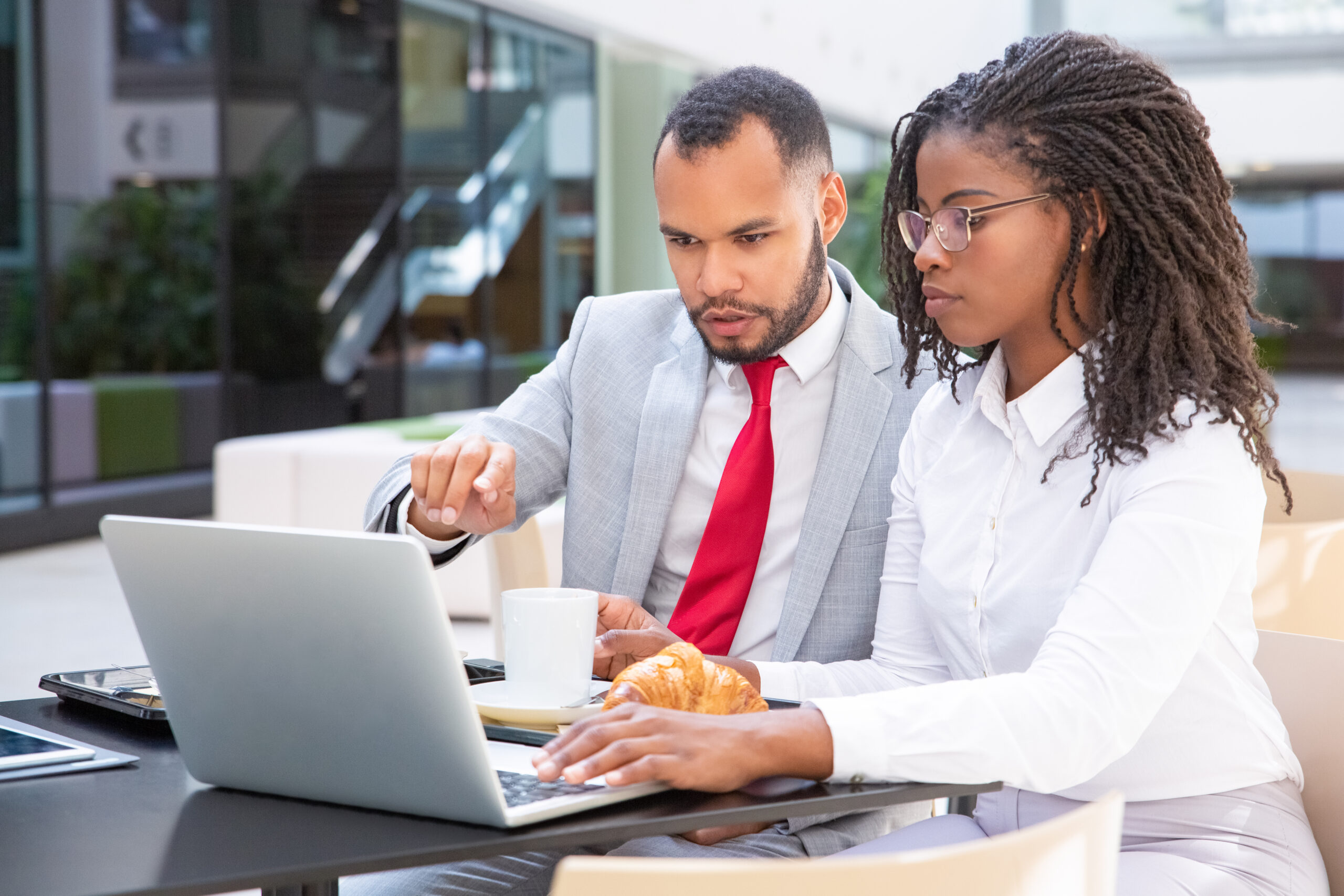 Serious coworkers watching and discussing presentation